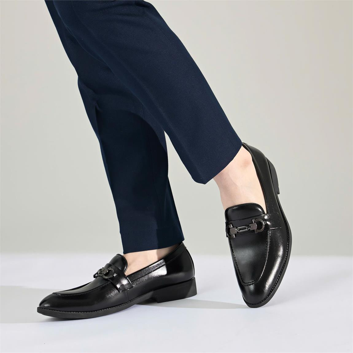 A person's legs wearing black shoesAI-generated content may be incorrect.